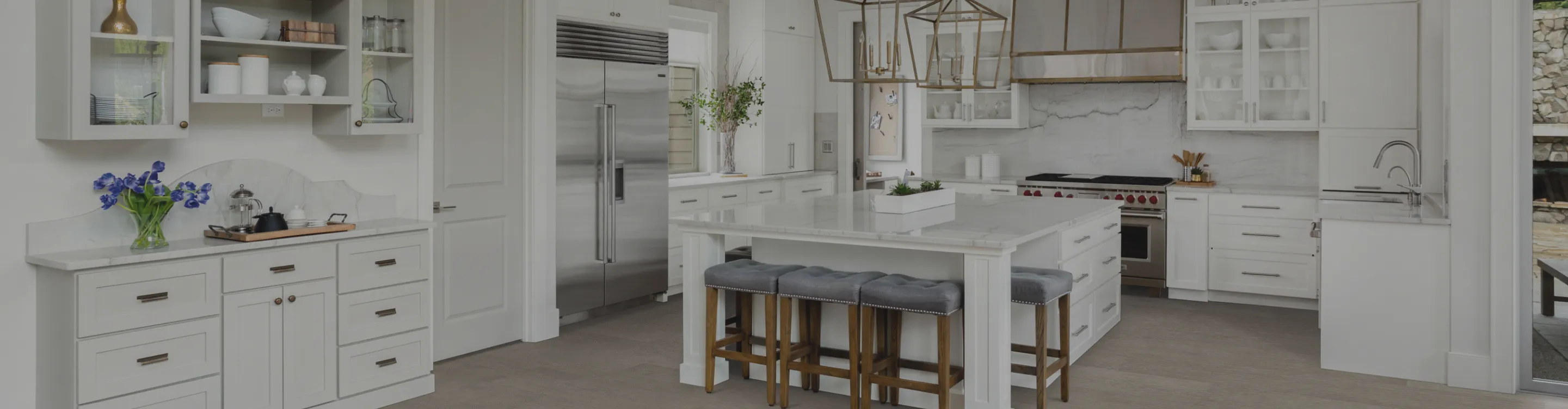 wood-look flooring in a kitchen with white cabinets and countertops