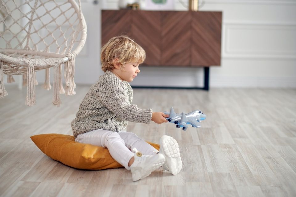 kid playing on hardwood floor